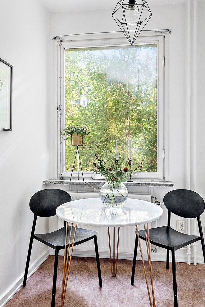 This is an example of a mid-sized scandinavian dining room in Stockholm with white walls and linoleum floors.