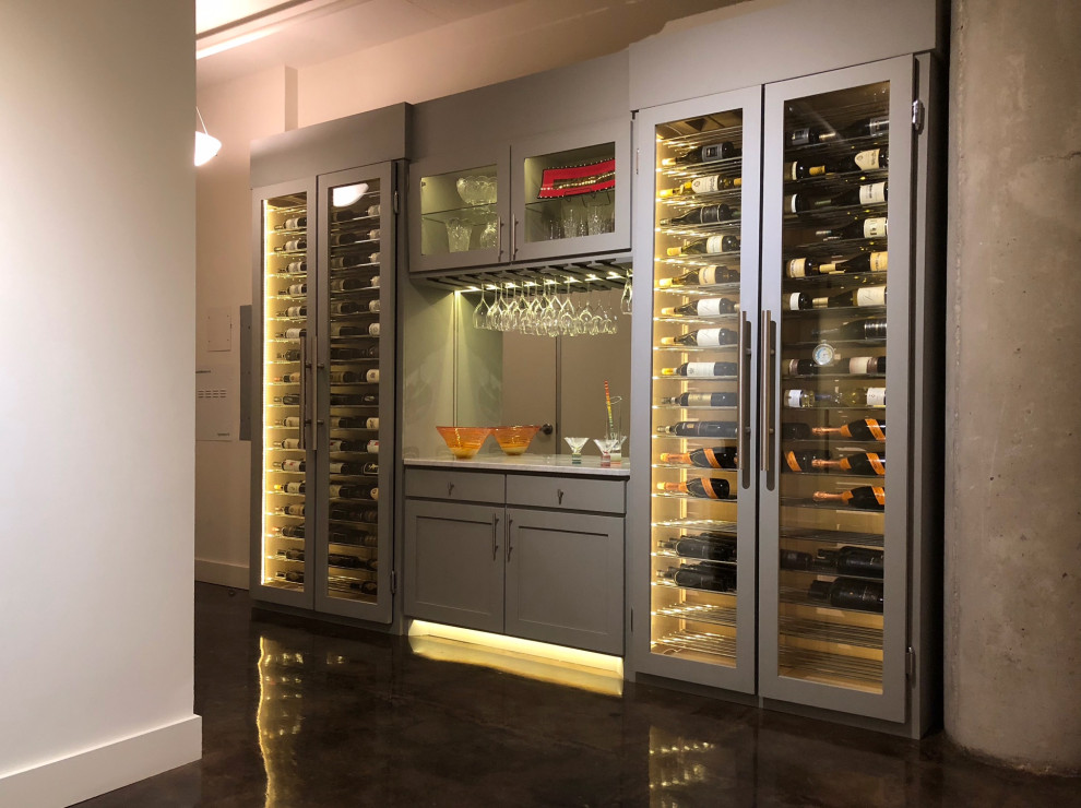 Large contemporary wine cellar in Miami with dark hardwood flooring, display racks and brown floors.