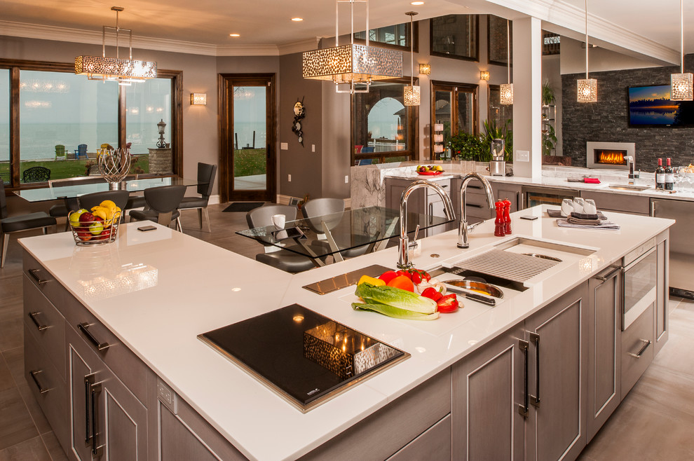Design ideas for a large transitional l-shaped open plan kitchen in Detroit with an undermount sink, recessed-panel cabinets, white cabinets, quartz benchtops, white splashback, subway tile splashback, stainless steel appliances, ceramic floors and multiple islands.