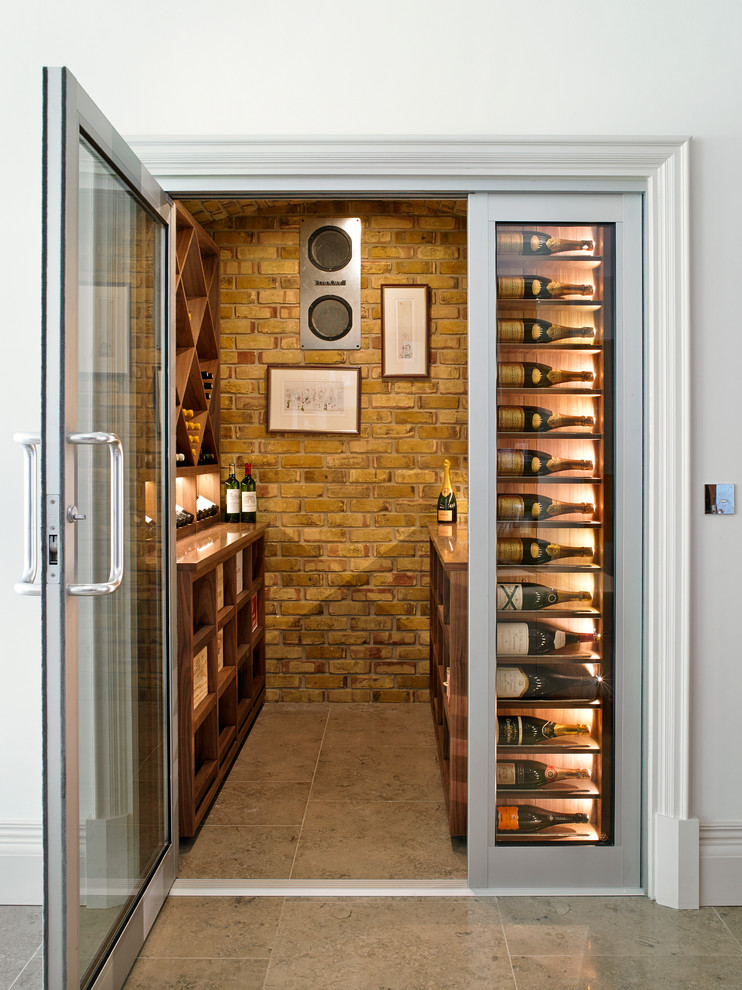 Inspiration for a transitional wine cellar in London with display racks.