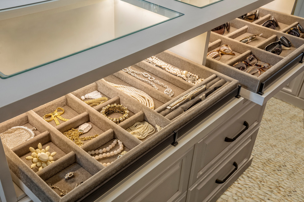 Design ideas for a large traditional women's storage and wardrobe in Orlando with raised-panel cabinets, white cabinets, carpet and beige floor.