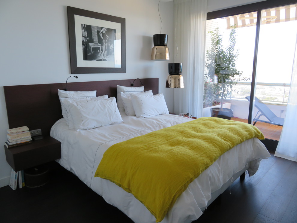 This is an example of a small transitional master bedroom in Marseille with white walls and dark hardwood floors.