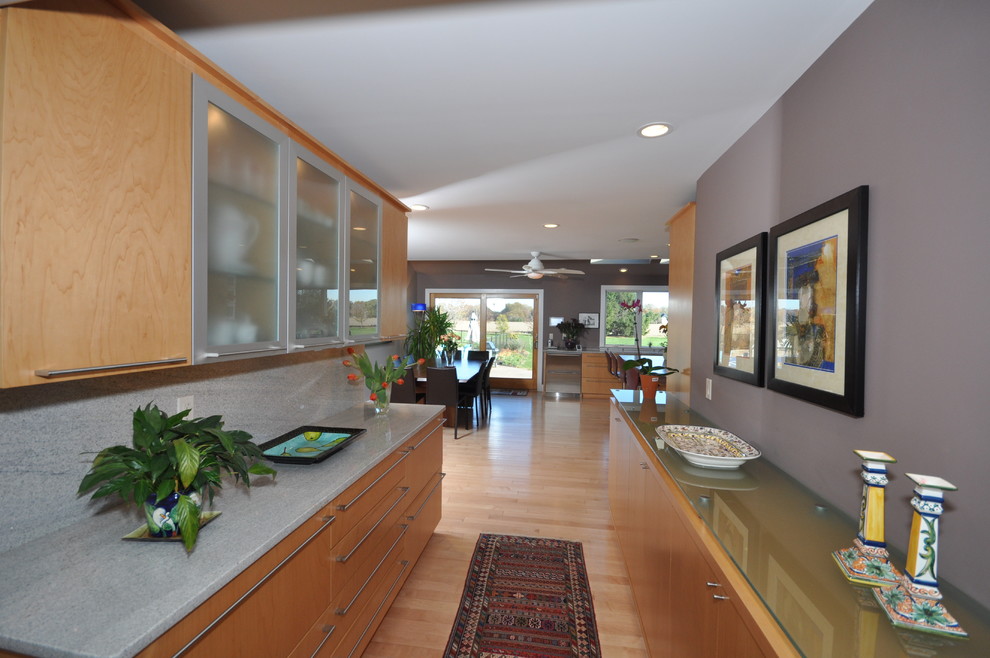 Design ideas for an expansive contemporary galley eat-in kitchen in Philadelphia with an undermount sink, flat-panel cabinets, light wood cabinets, granite benchtops, grey splashback, stone slab splashback, stainless steel appliances, light hardwood floors and with island.
