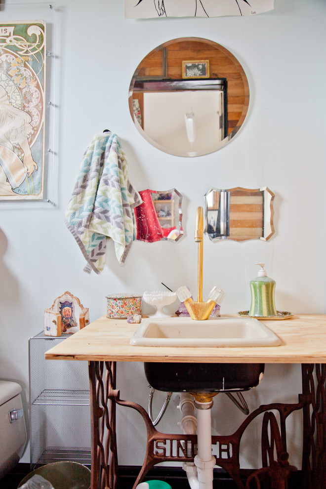 Design ideas for an eclectic powder room in Austin with a drop-in sink, wood benchtops and beige benchtops.