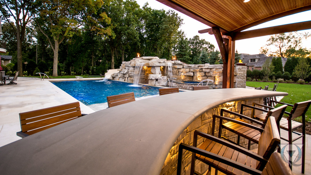 Example of a large mountain style backyard stone and rectangular natural pool fountain design in Chicago