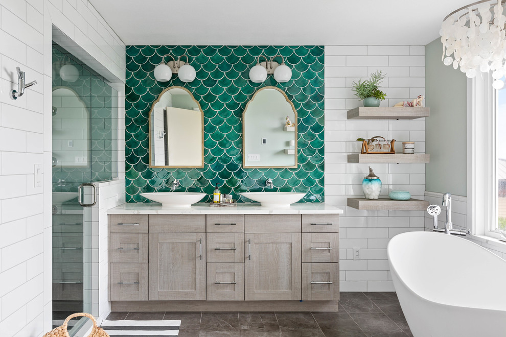 Large beach style master bathroom in Seattle with grey cabinets, a freestanding tub, an alcove shower, green tile, porcelain floors, a vessel sink, engineered quartz benchtops, grey floor, a hinged shower door, white benchtops, shaker cabinets, subway tile and green walls.