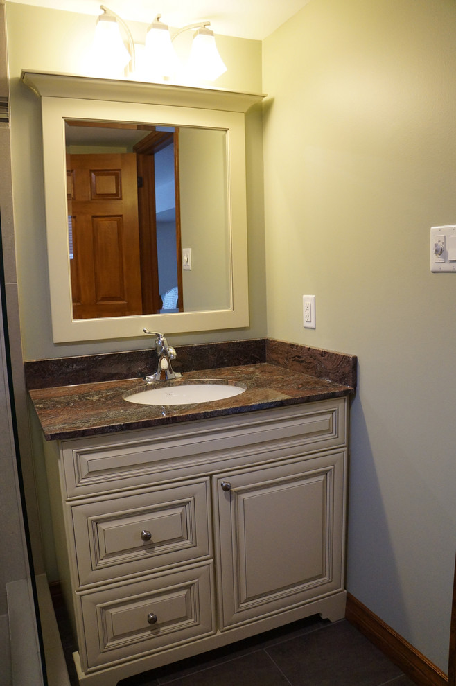 Inspiration for a small transitional porcelain tile and gray tile porcelain tile corner shower remodel in Toronto with an undermount sink, raised-panel cabinets, white cabinets, granite countertops, a two-piece toilet and green walls