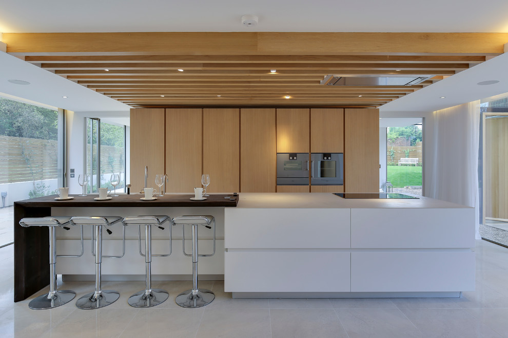 This is an example of a contemporary galley kitchen in London with with island.