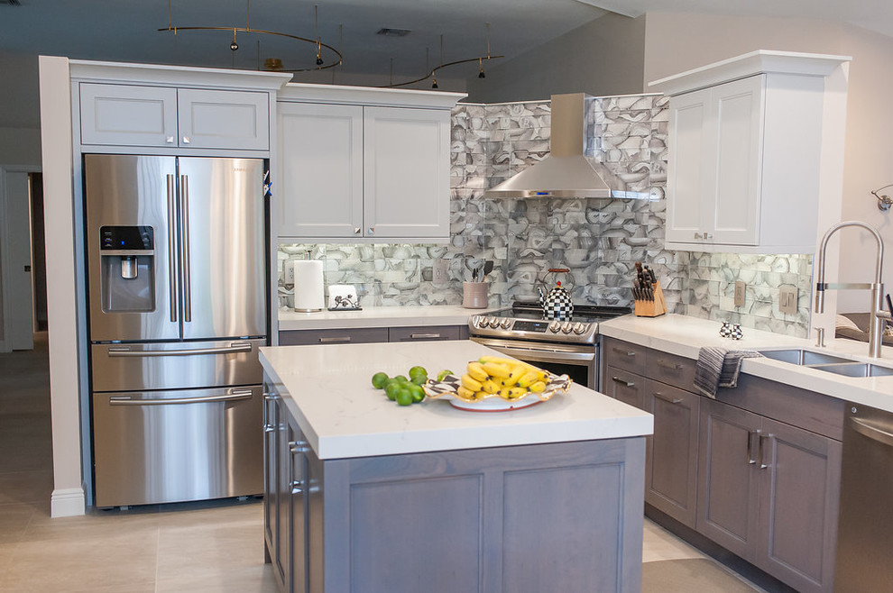 Eat-in kitchen - mid-sized transitional u-shaped porcelain tile and beige floor eat-in kitchen idea in Miami with an undermount sink, shaker cabinets, gray cabinets, quartz countertops, gray backsplash, glass tile backsplash, stainless steel appliances, an island and white countertops