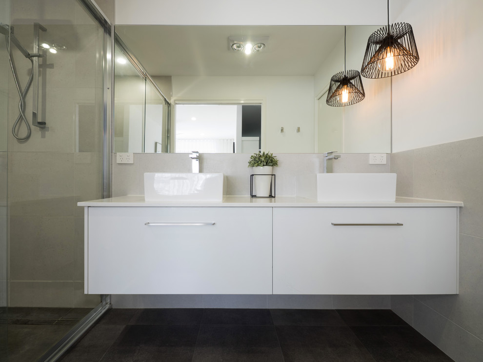 Design ideas for a large contemporary 3/4 bathroom in Brisbane with white cabinets, a double shower, gray tile, ceramic tile, white walls, ceramic floors, a vessel sink and granite benchtops.