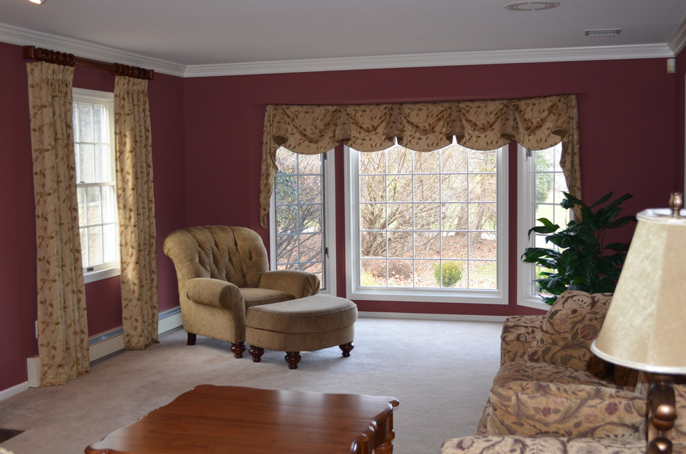 Photo of a traditional living room in New York with red walls and carpet.