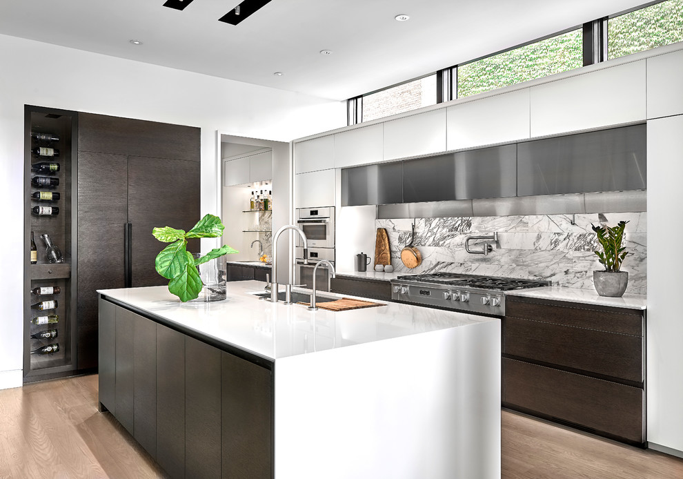 Mid-sized contemporary l-shaped kitchen in Chicago with an undermount sink, flat-panel cabinets, dark wood cabinets, solid surface benchtops, stone tile splashback, stainless steel appliances, light hardwood floors, with island and beige floor.