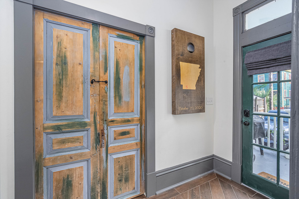 Источник вдохновения для домашнего уюта: узкая прихожая среднего размера в стиле неоклассика (современная классика) с белыми стенами, полом из керамической плитки, одностворчатой входной дверью, зеленой входной дверью и коричневым полом