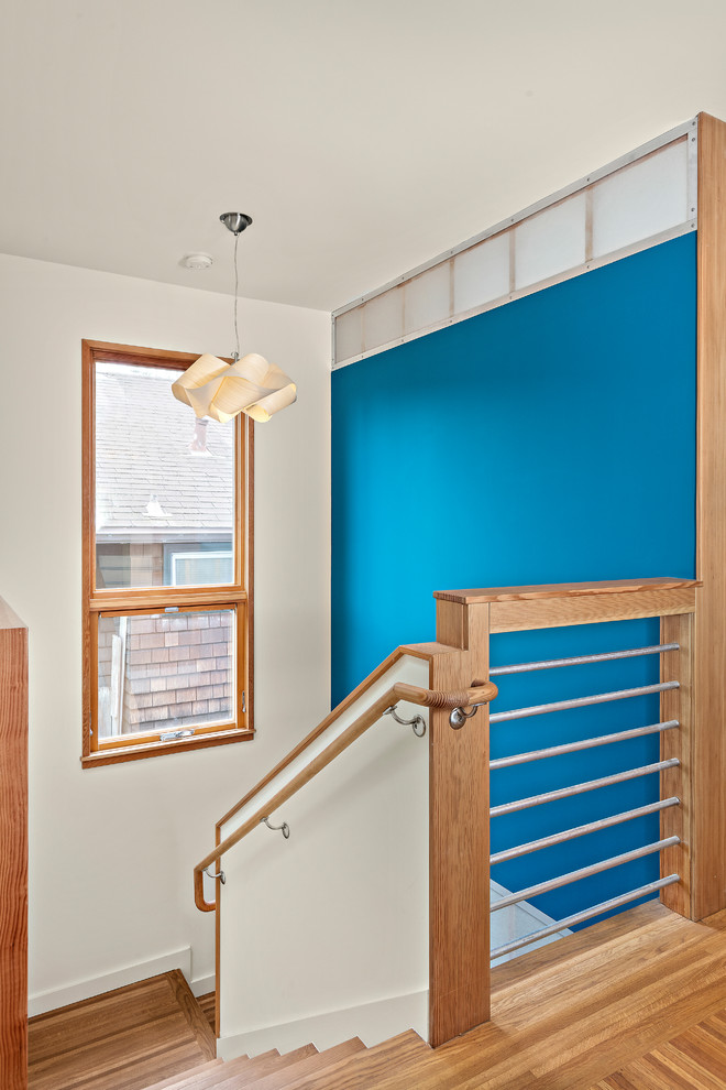 Mid-sized contemporary wood u-shaped staircase in San Francisco with wood risers and wood railing.