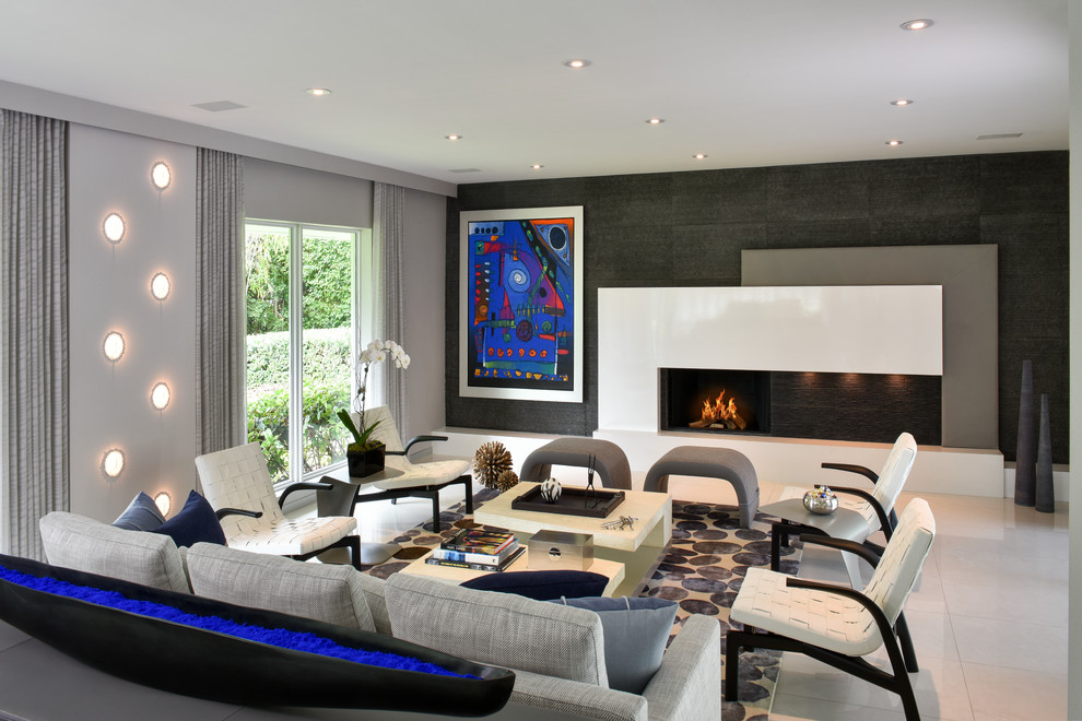 Photo of a large contemporary formal open concept living room in Miami with grey walls, limestone floors and a tile fireplace surround.