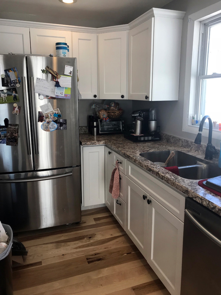 Eat-in kitchen - mid-sized transitional eat-in kitchen idea with a double-bowl sink, recessed-panel cabinets, white cabinets, laminate countertops, stainless steel appliances, an island and beige countertops