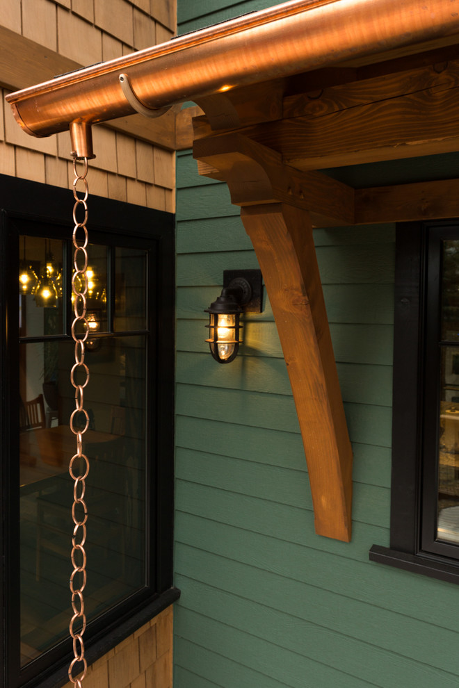 Mid-sized mountain style backyard deck photo with an awning