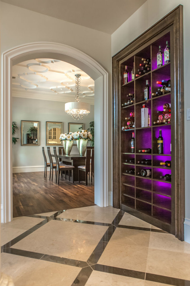 This is an example of a transitional wine cellar in Dallas with display racks and multi-coloured floor.