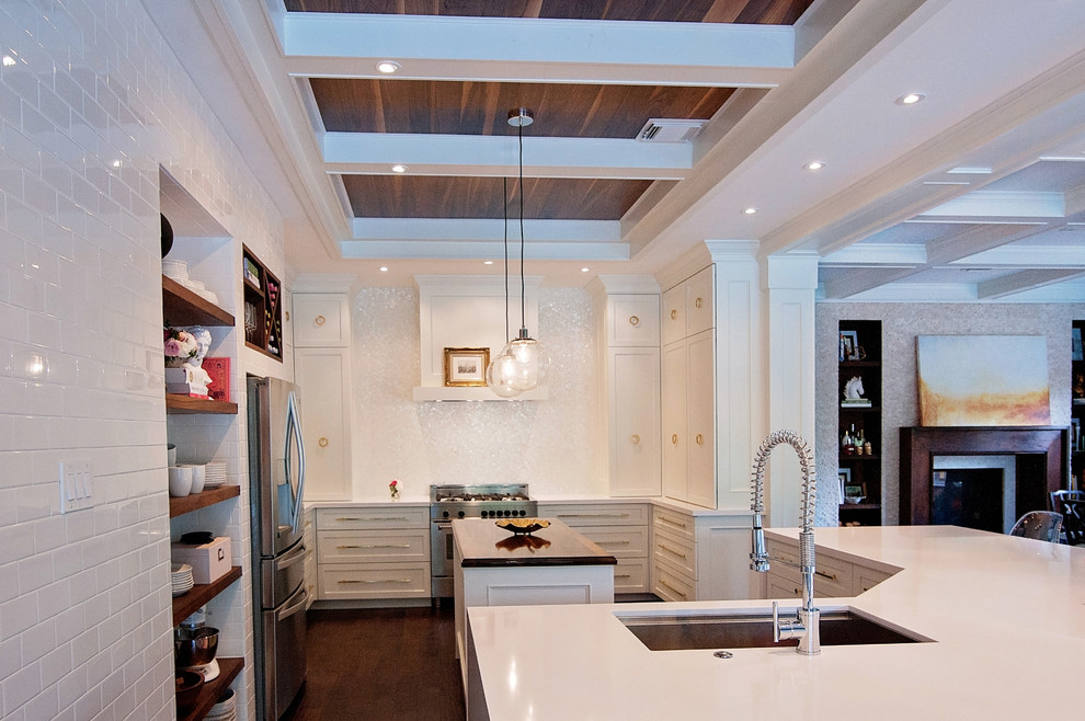 Open concept kitchen - large transitional dark wood floor open concept kitchen idea in Houston with a single-bowl sink, shaker cabinets, white cabinets, quartz countertops, white backsplash, mosaic tile backsplash, stainless steel appliances and two islands