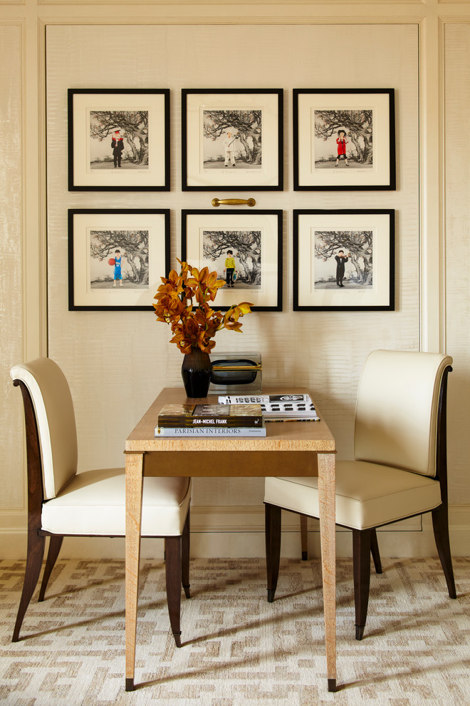 This is an example of a transitional study room in New York with beige walls, carpet and a freestanding desk.