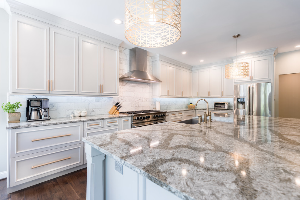 Inspiration for a mid-sized traditional l-shaped eat-in kitchen in DC Metro with a farmhouse sink, beaded inset cabinets, white cabinets, granite benchtops, white splashback, marble splashback, stainless steel appliances, dark hardwood floors, with island and brown floor.