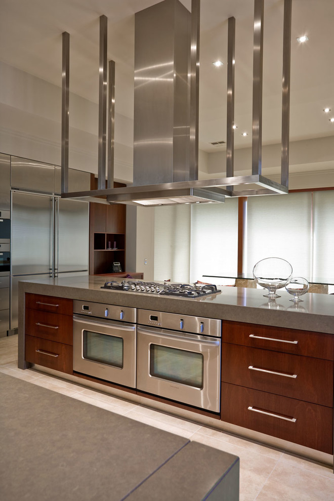 Photo of an expansive modern eat-in kitchen in Sydney with an undermount sink, flat-panel cabinets, dark wood cabinets, quartz benchtops, stainless steel appliances, travertine floors and multiple islands.
