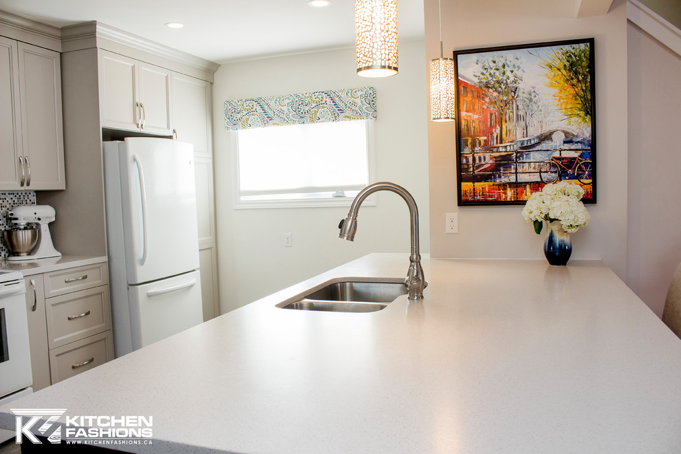 Example of a mid-sized transitional single-wall ceramic tile open concept kitchen design with an undermount sink, shaker cabinets, gray cabinets, solid surface countertops, gray backsplash, mosaic tile backsplash, white appliances and an island