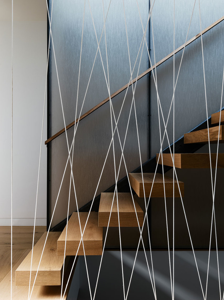 Inspiration for a small contemporary wooden floating cable railing staircase remodel in San Francisco with wooden risers