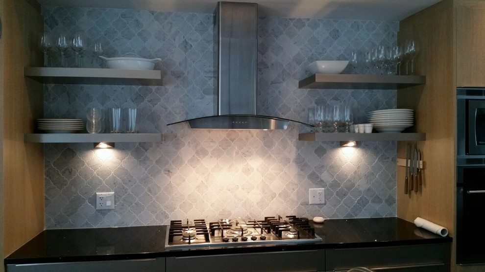 Transitional kitchen photo in Calgary with gray cabinets, granite countertops, gray backsplash, stone tile backsplash and stainless steel appliances