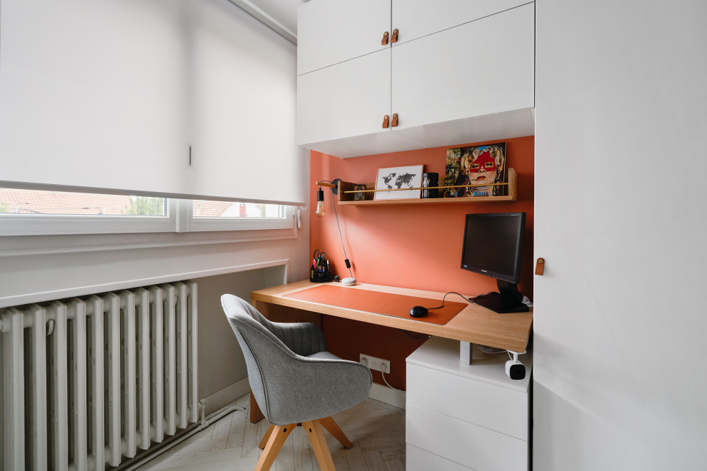 This is an example of a contemporary home office in Paris with laminate floors and white floors.