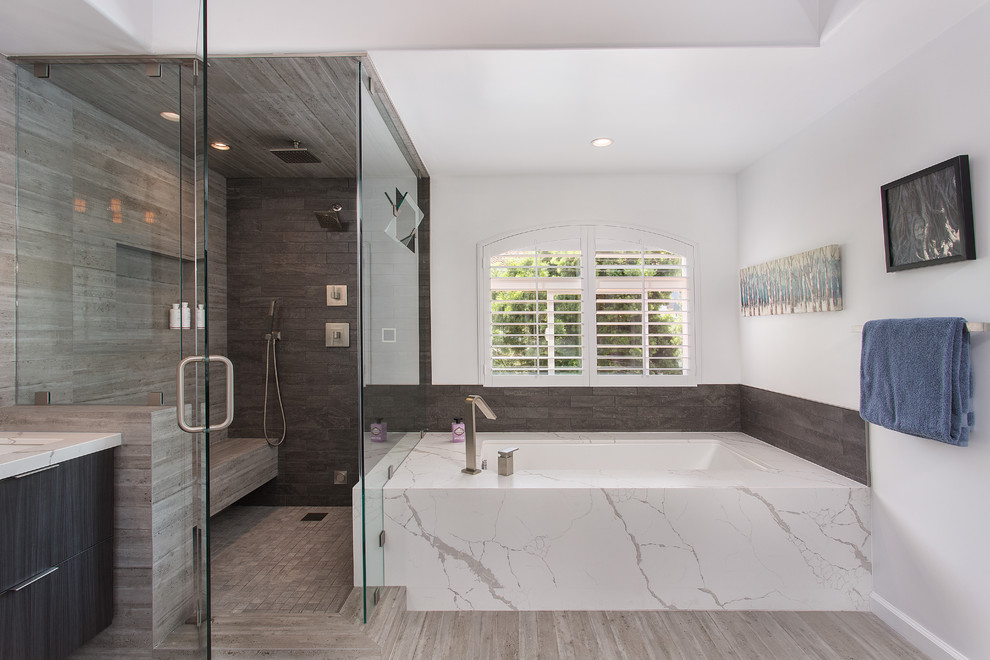 Large scandinavian master bathroom in Los Angeles with raised-panel cabinets, dark wood cabinets, a corner tub, an alcove shower, brown tile, ceramic tile, white walls, light hardwood floors, an undermount sink, quartzite benchtops, brown floor, a hinged shower door and white benchtops.