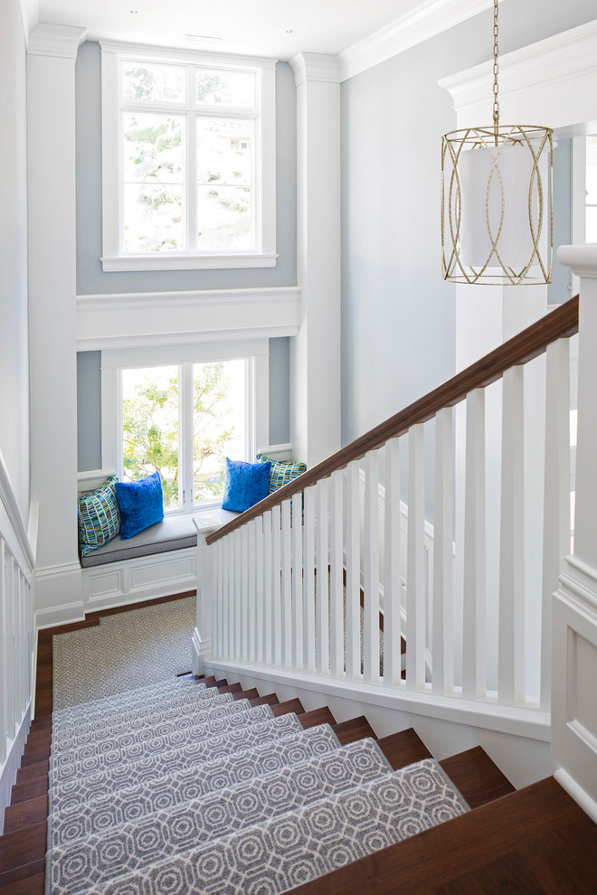 Inspiration for a large transitional wood u-shaped staircase in Minneapolis with wood railing.
