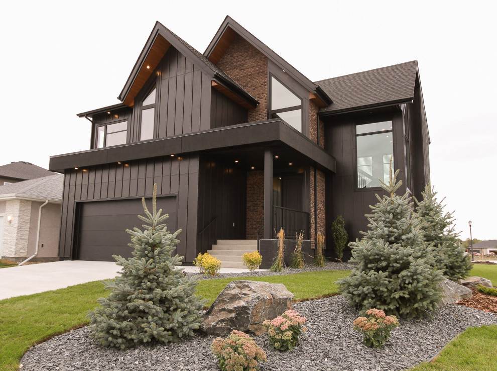 Contemporary two-storey black house exterior in Other with concrete fiberboard siding, a gable roof and a shingle roof.