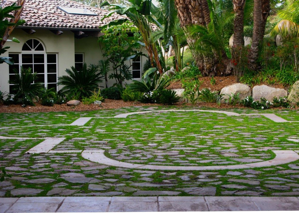 Inspiration for a mid-sized traditional partial sun backyard stone landscaping in San Diego.