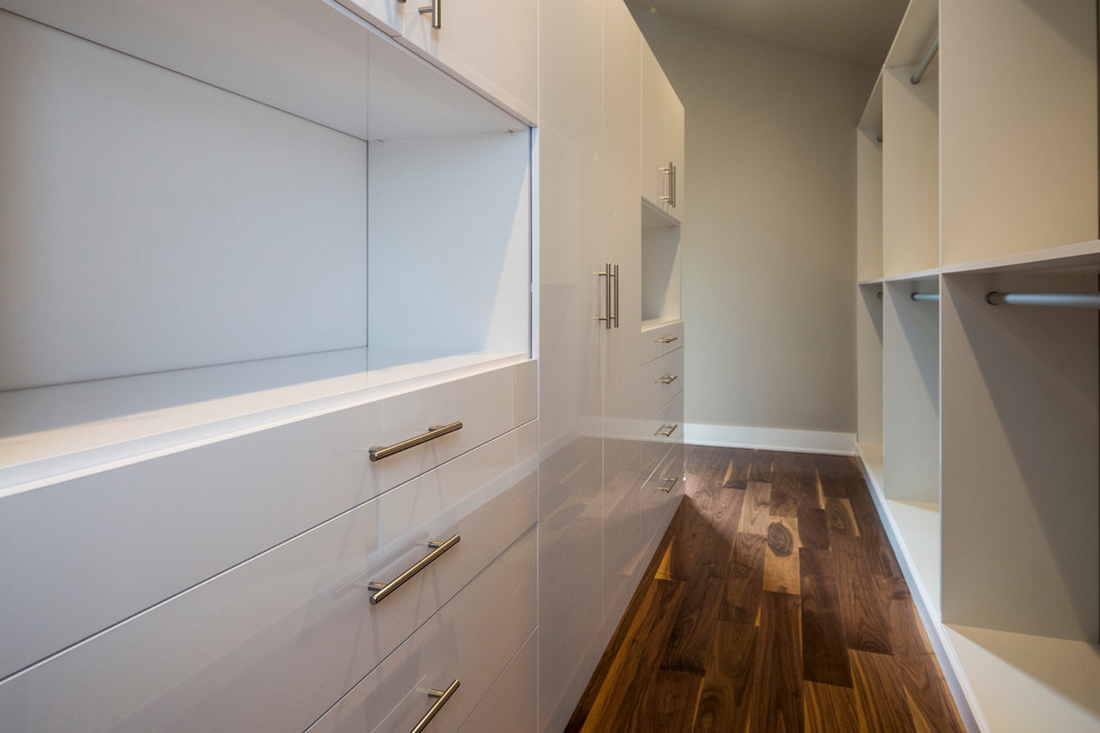 Inspiration for a contemporary gender-neutral walk-in wardrobe in New York with flat-panel cabinets and white cabinets.