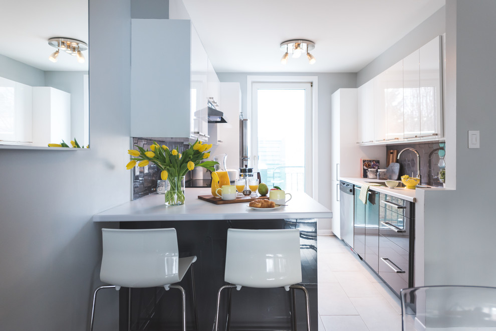 Inspiration for a small contemporary galley medium tone wood floor eat-in kitchen remodel in Montreal with an undermount sink, flat-panel cabinets, white cabinets, laminate countertops, gray backsplash, ceramic backsplash, stainless steel appliances and a peninsula