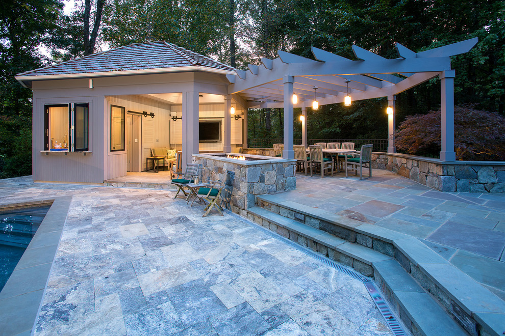 Expansive traditional backyard patio in DC Metro with an outdoor kitchen, natural stone pavers and a pergola.