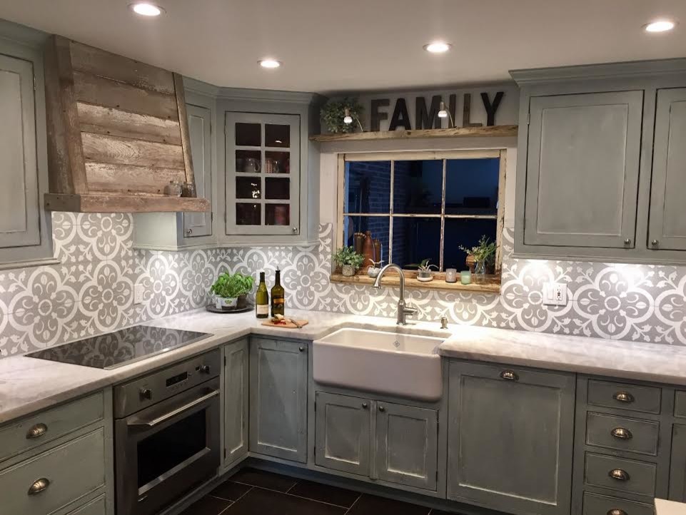 Example of a mid-sized mountain style l-shaped ceramic tile and brown floor enclosed kitchen design in Miami with a farmhouse sink, beaded inset cabinets, gray cabinets, marble countertops, gray backsplash, cement tile backsplash, stainless steel appliances and no island