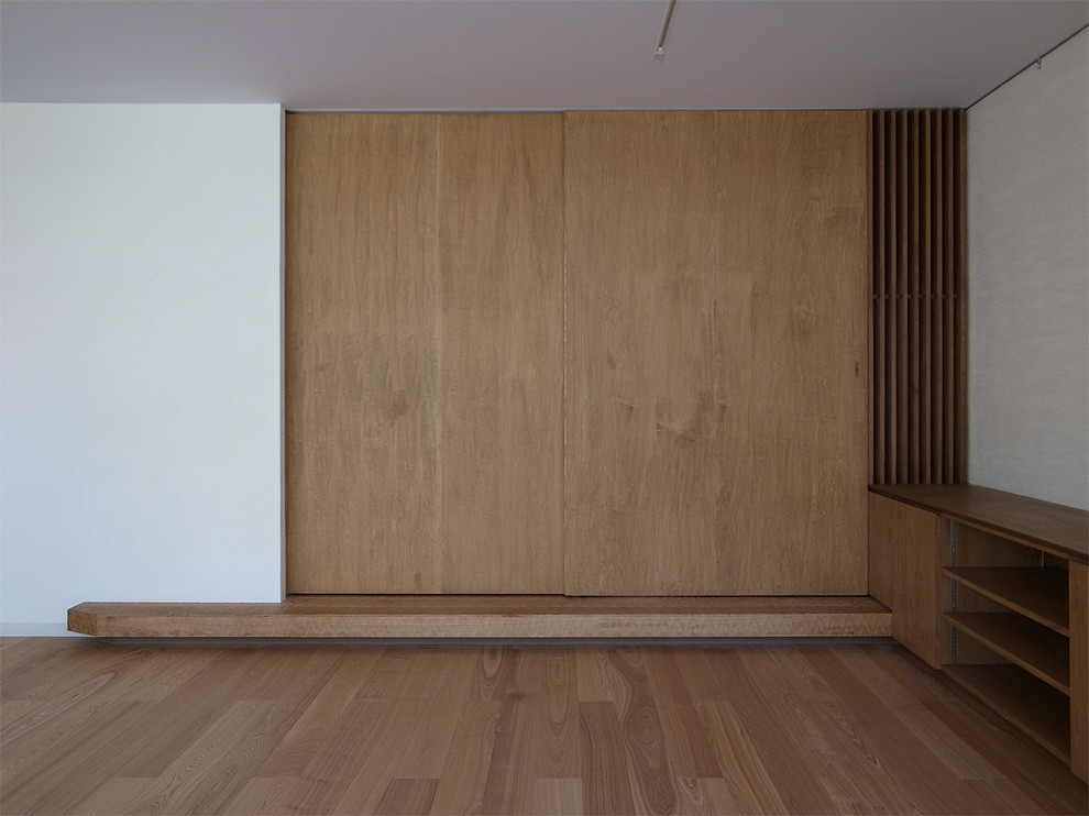 This is an example of an asian master bedroom in Yokohama with white walls and tatami floors.