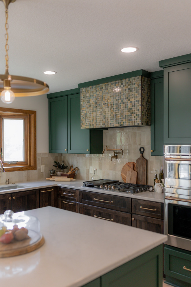 Eat-in kitchen - mid-sized transitional l-shaped light wood floor and brown floor eat-in kitchen idea with an undermount sink, recessed-panel cabinets, green cabinets, quartz countertops, beige backsplash, terra-cotta backsplash, stainless steel appliances, two islands and beige countertops