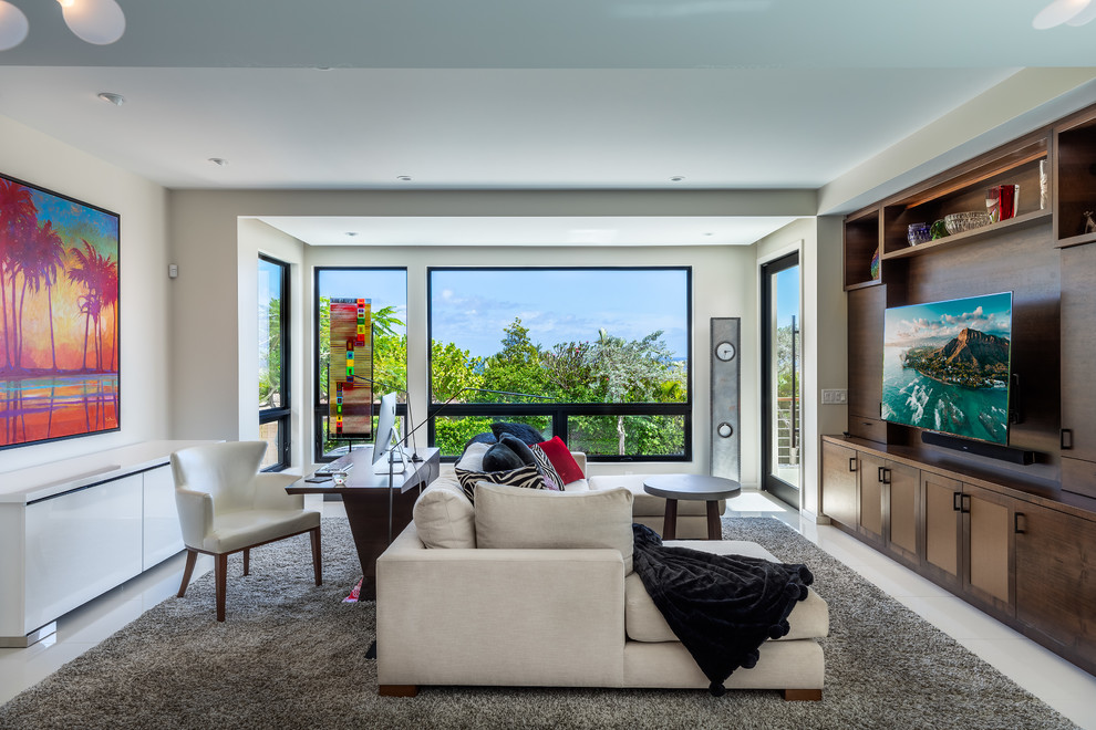 Photo of a large modern open concept living room in Hawaii with white walls, no fireplace, a wall-mounted tv and white floor.