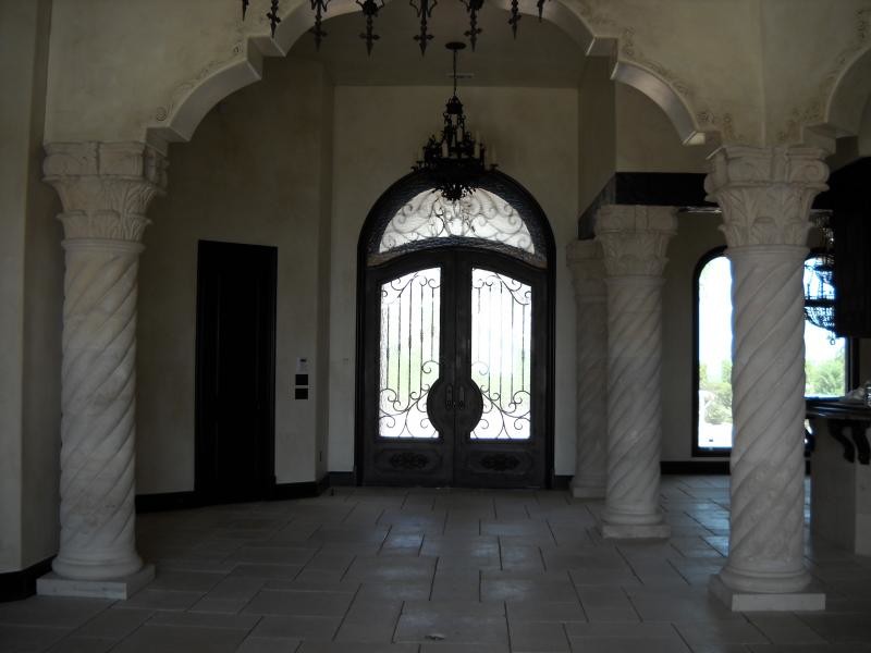 Inspiration for a large ceramic tile foyer remodel with beige walls and a dark wood front door