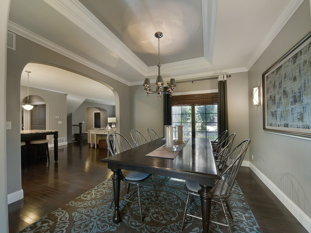 Traditional dining room in Denver with grey walls and dark hardwood floors.