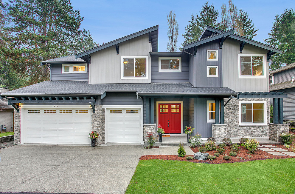 Photo of a contemporary two-storey grey exterior in Seattle with mixed siding and a shed roof.