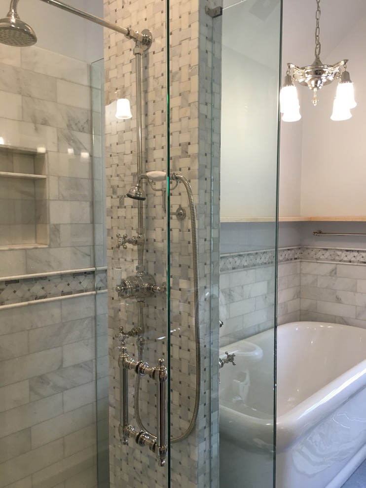 Photo of a mid-sized traditional master bathroom in Seattle with furniture-like cabinets, light wood cabinets, a freestanding tub, a corner shower, a two-piece toilet, gray tile, stone tile, linoleum floors, grey walls, a console sink and grey floor.