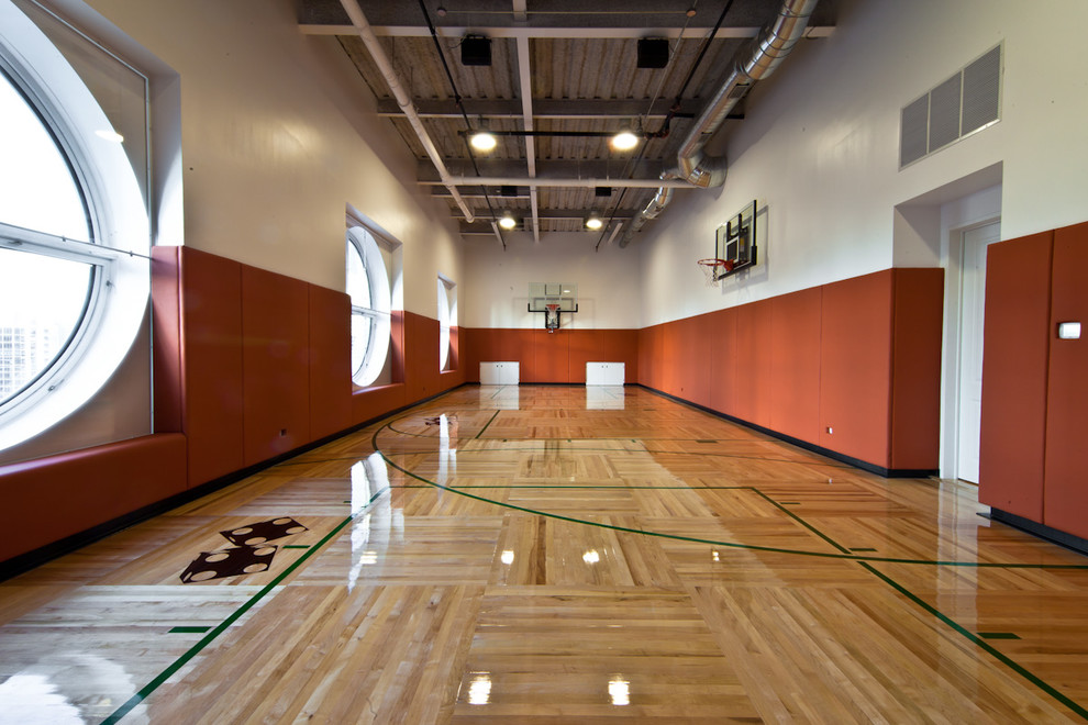 This is an example of an expansive contemporary indoor sport court in Chicago with light hardwood floors.