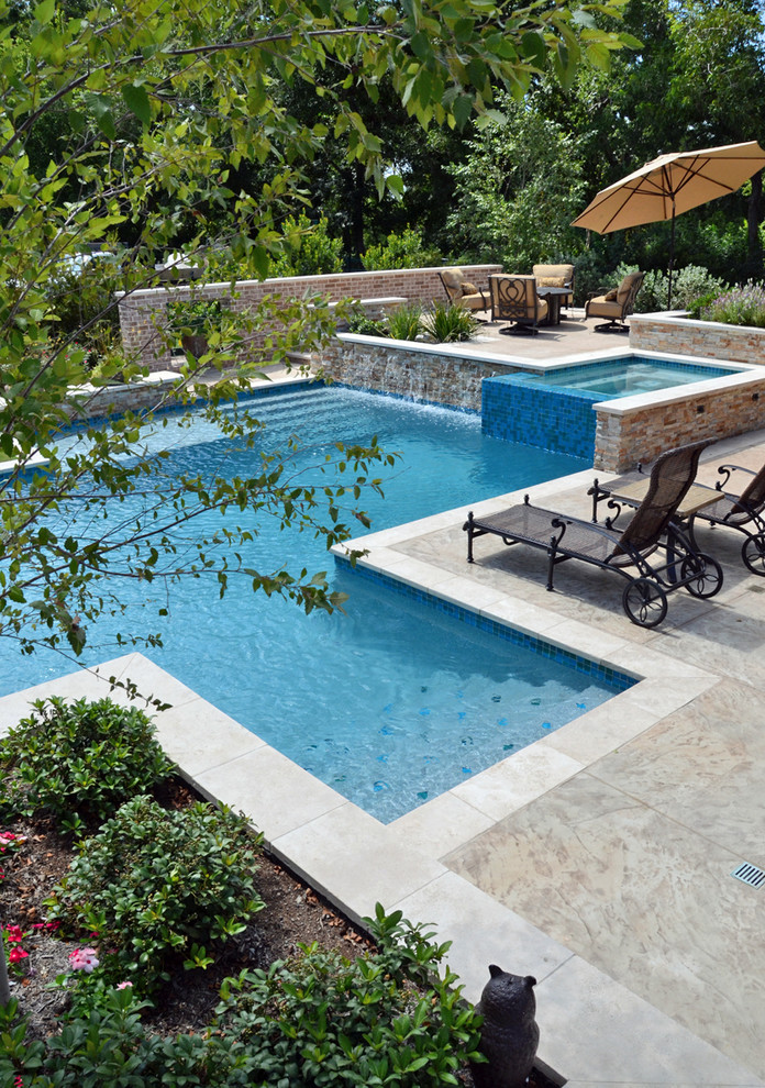 Photo of an expansive country backyard custom-shaped natural pool in Houston with a hot tub and tile.