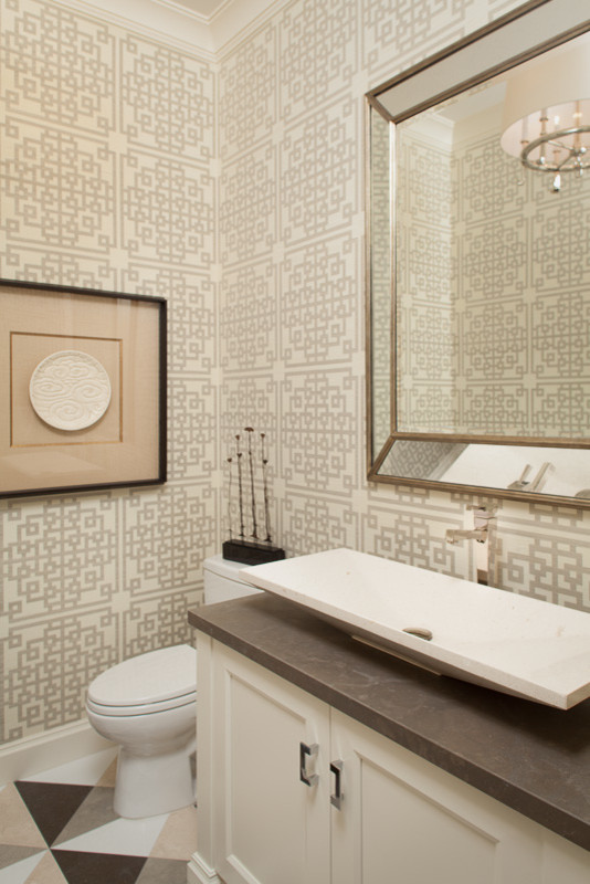 Photo of a small transitional powder room in Miami with a one-piece toilet, multi-coloured tile, ceramic floors, recessed-panel cabinets, beige walls, a vessel sink, concrete benchtops, white cabinets and grey benchtops.