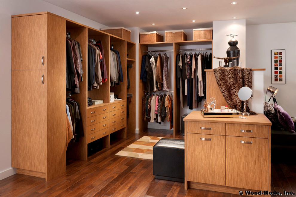 This is an example of a large contemporary gender-neutral walk-in wardrobe in Los Angeles with flat-panel cabinets, medium wood cabinets, dark hardwood floors and brown floor.