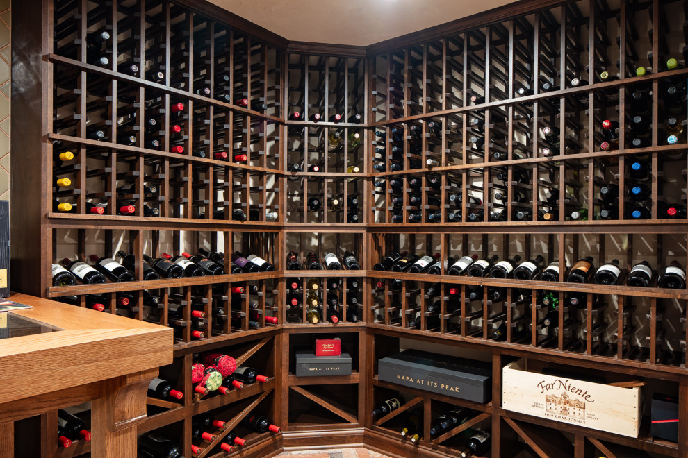 Inspiration for a mid-sized traditional wine cellar in Cincinnati with brick floors, display racks and blue floor.